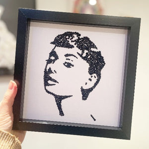Handmade Audrey Hepburn wall art in a black frame