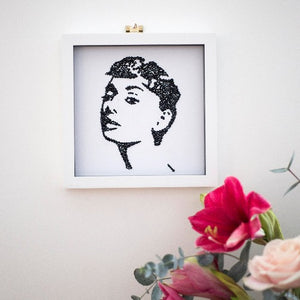 Wall mounted black and white portrait of Audrey Hepburn