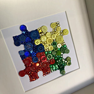 Autism Awareness puzzle piece button art. Framed picture.