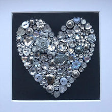 Load image into Gallery viewer, silver sparkly heart button art on black background. Framed picture.