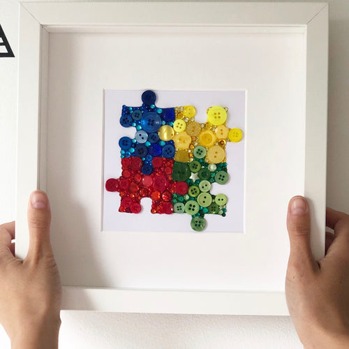 Autism Awareness puzzle piece button art. Framed picture.